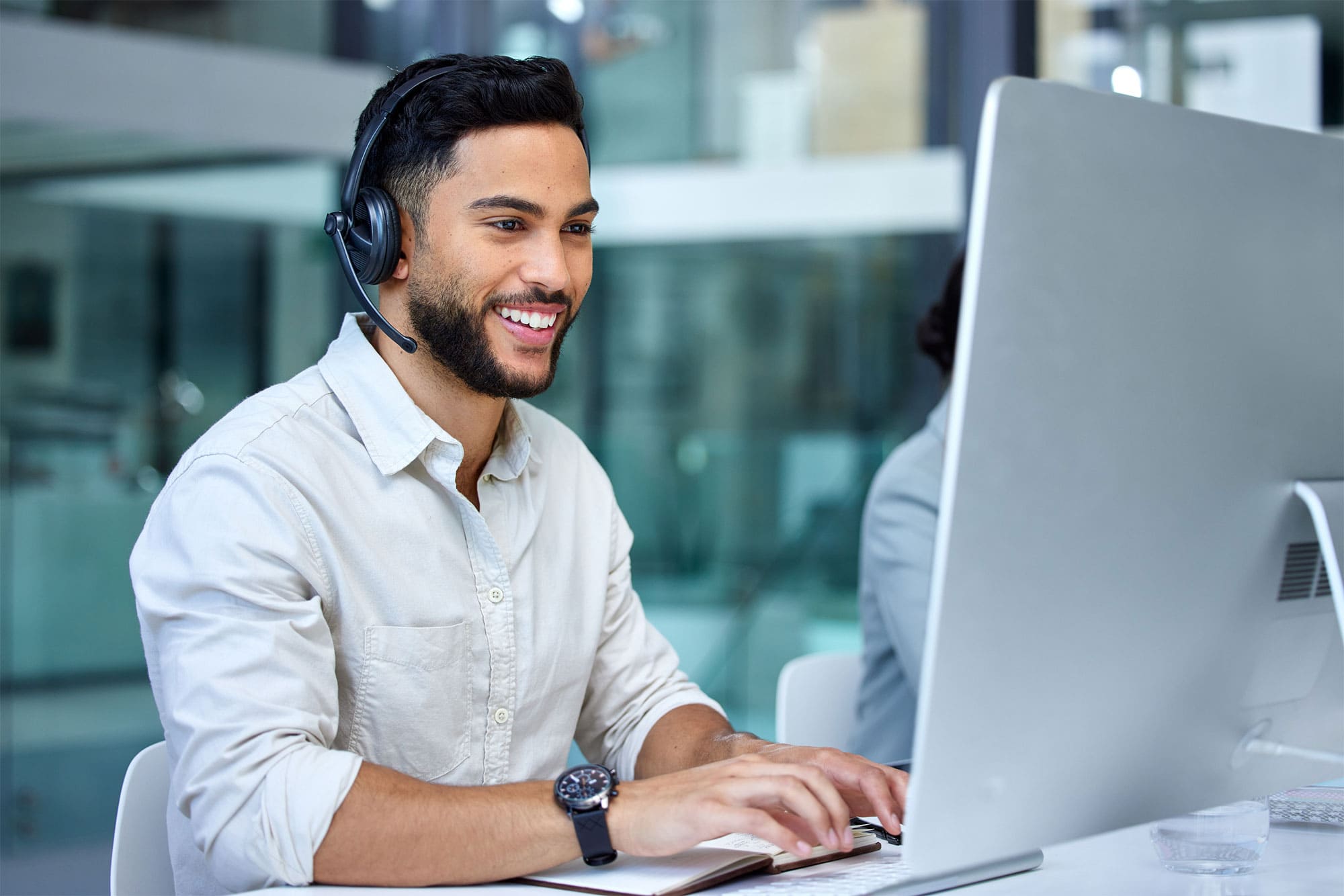 A tech support person sitting at desktop computer